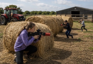 Children enjoying an outdoor Lasertag party on a farm in Cornwall